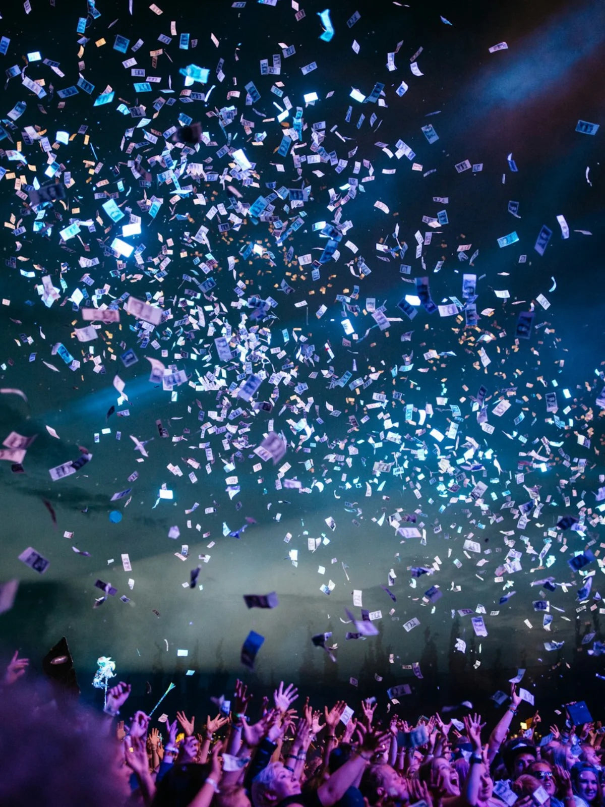 view of a crowd at a concert with a bunch of white confettis